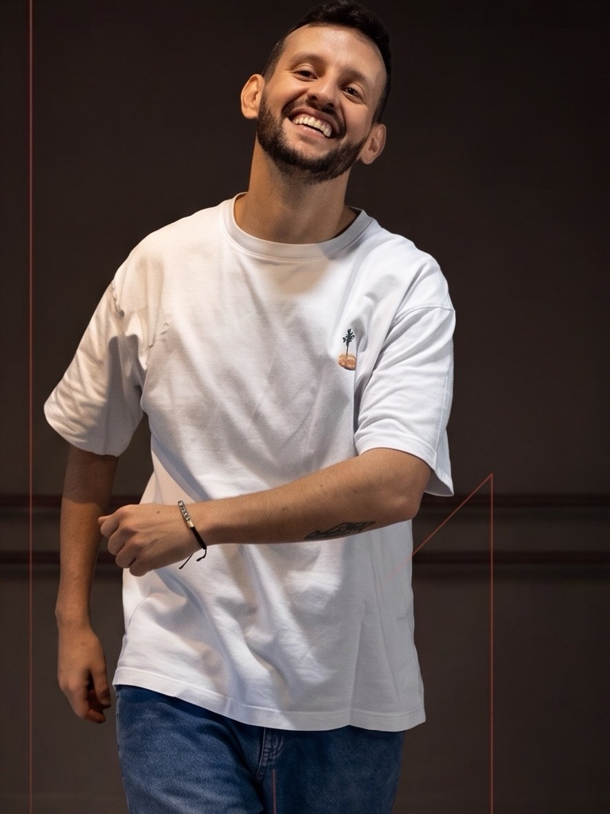 Pedro Nantes mid-step in a white T-shirt, laughing, in a dance studio. Photo from his September 25 post.